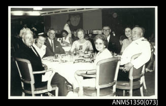 Captain Dun and group sitting at dining table