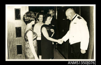 Captain Dun shaking the hand of unidentified woman