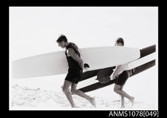 Two surfers and their boards