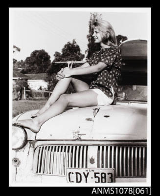 Jane Robinson sitting on a Ford