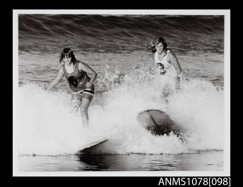 Two girls surfing during the Australian Titles Heat