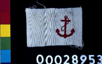 Red anchor embroidered on white cotton