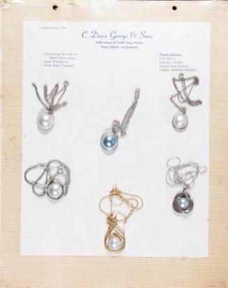 An album page with six half pearl (or mabe pearl) necklaces, attached with string