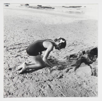 Girl kneeling on sand, 1952