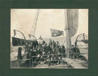 Crew at stern of naval vessel