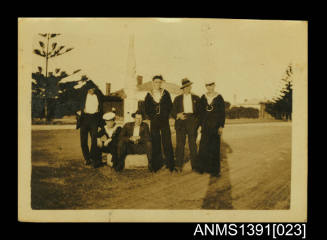 Photograph depicting a group of men posing for the camera