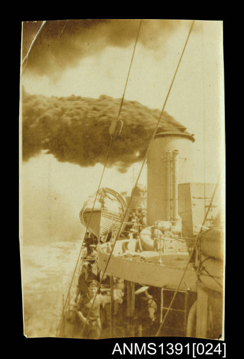 Photograph depicting black smoke coming from a ship's funnel