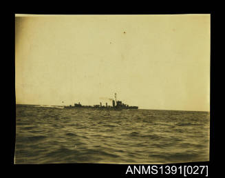 Photograph depicting a starboard view of two war ships at sea