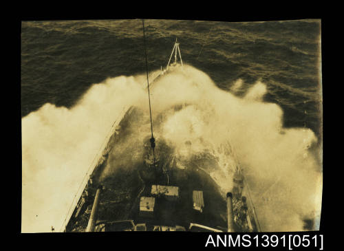 Photograph depicting a bird's eye view of a ship on rough seas