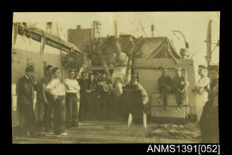 A man doing acrobatics on board a ship