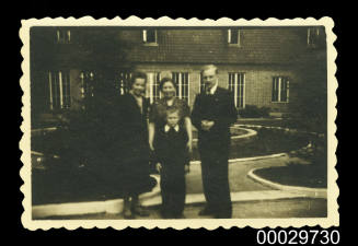 A family standing in front of a house