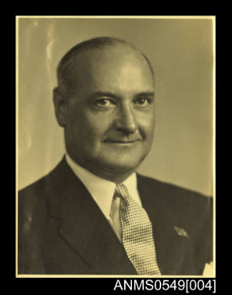 Photograph depicting portrait of a man wearing a suit