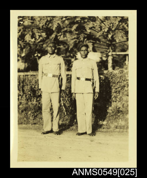 Photograph depicting two men wearing uniform and no shoes