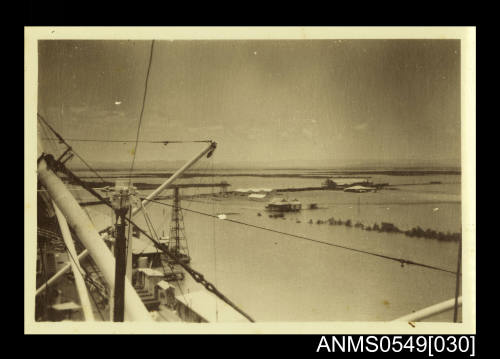 Photograph depicting a view of a landscape taken from a ship