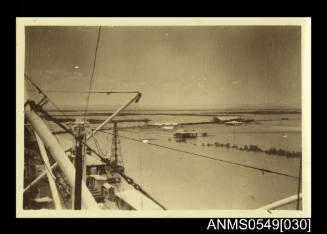 Photograph depicting a view of a landscape taken from a ship