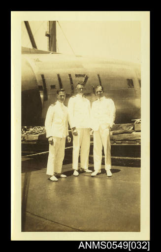 Photograph depicting three men in uniform posing for the camera