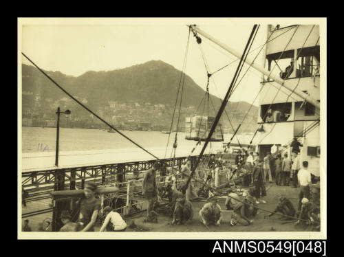 Photograph depicting men working on a ship's deck