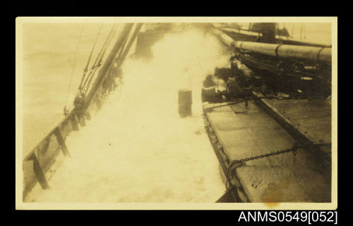 Photograph depicting a view of a ship's deck in rough waters