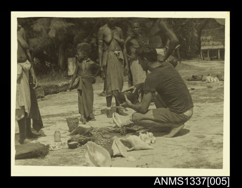 Photograph of locals trading shells for kerosene