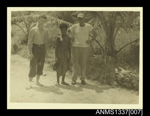 Belle of the village. The joker in the cap is a Yank Roman Catholic Missionary