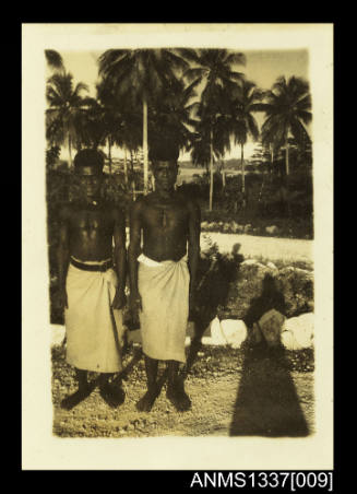 Photograph of two men dressed in traditional clothing