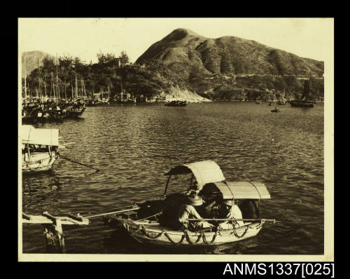 Photograph of a number of native boats moored on the water