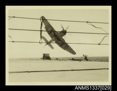 Photograph of a Royal Australian Navy Hawker Sea Fury aircraft missing the wire above the flight deck of HMAS SYDNEY III