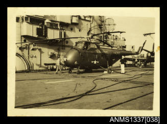 Photograph of US Army Sikorsky H-19 helicopter on deck of HMAS SYDNEY III