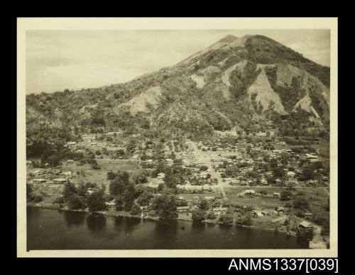 Photograph of a small town at the bottom of a mountain