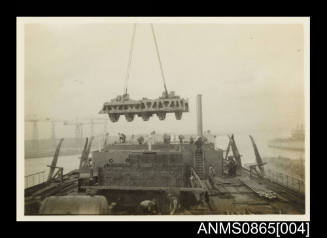 Photograph of KANIMBLA's main engine cylinder head being lowered into the engine room