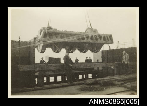 Photograph of KANIMBLA's main engine cylinder head being lowered into the engine room