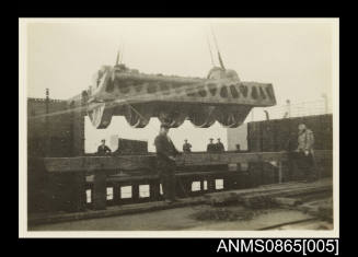 Photograph of KANIMBLA's main engine cylinder head being lowered into the engine room