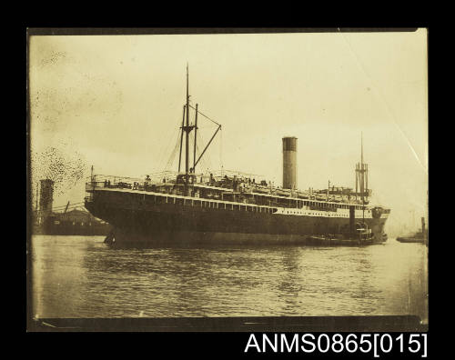 Photograph depicting vessel approaching berth with tug along starboard side