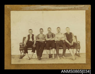 Photograph depicting five men