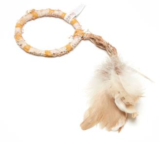 Pukumani armband with feather tuft