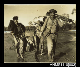 Led by Lieutenant-Commander J.J. Cody, RAN, the survey party trudges from the mangroves at Torment Point (King Sound)