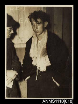 Photograph of a young man being questioned or interviewed