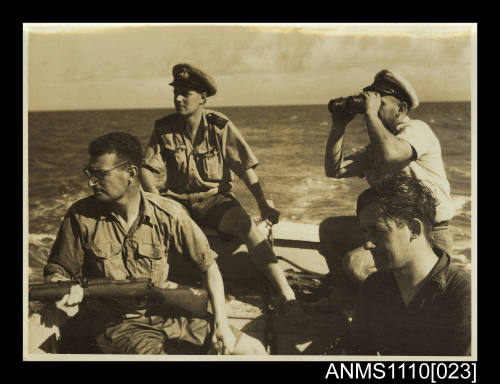 Photograph of four men in a boat