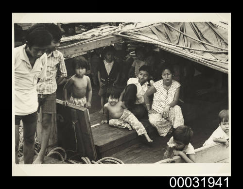 Photograph of the Lu family on the deck of TU DO in Darwin Harbour