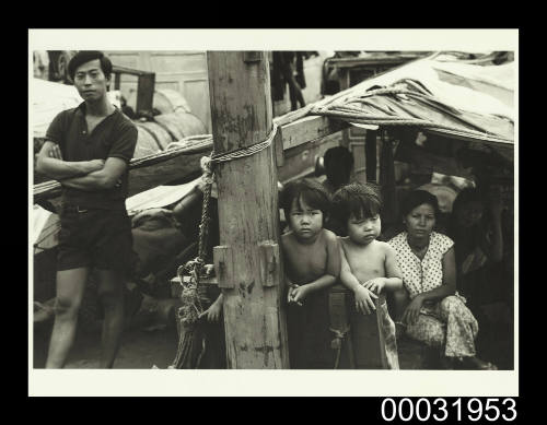 Photograph of the Lu family on the deck of TU DO in Darwin Harbour