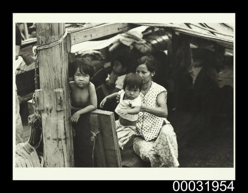 Photograph of the Lu family on the deck of TU DO in Darwin Harbour