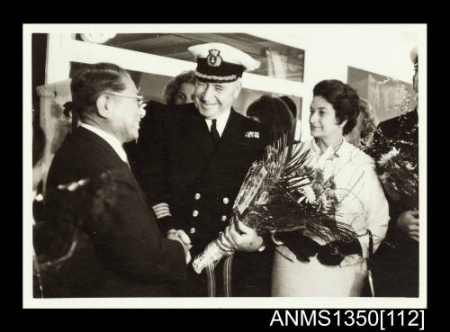 Captain Dun holding a bunch of flowers