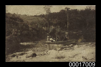 People in a rowing dinghy on a river