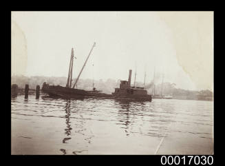 Small cargo ship unloading timber