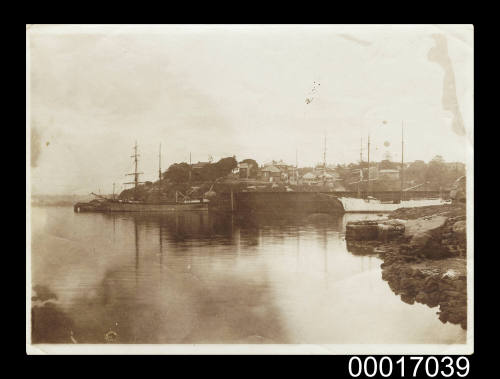 Sailing ships at anchor in a bay