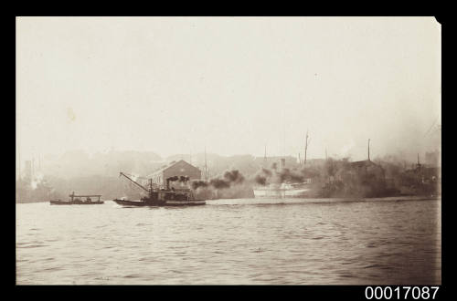 Small steam work boat billowing smoke