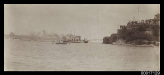 Group of spectators looking at the harbour