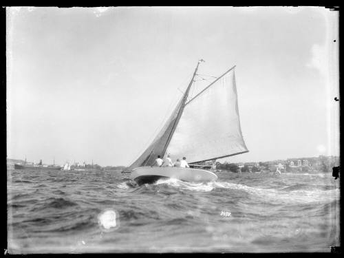 Gaff-rigged yacht heeled over on harbour