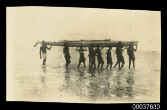 Boys carrying Oskar Speck's canoe ashore at Orokolo