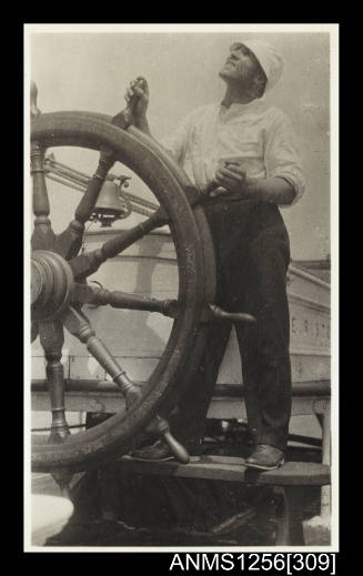 Photograph depicting ER STERLING's helmsman at the wheel